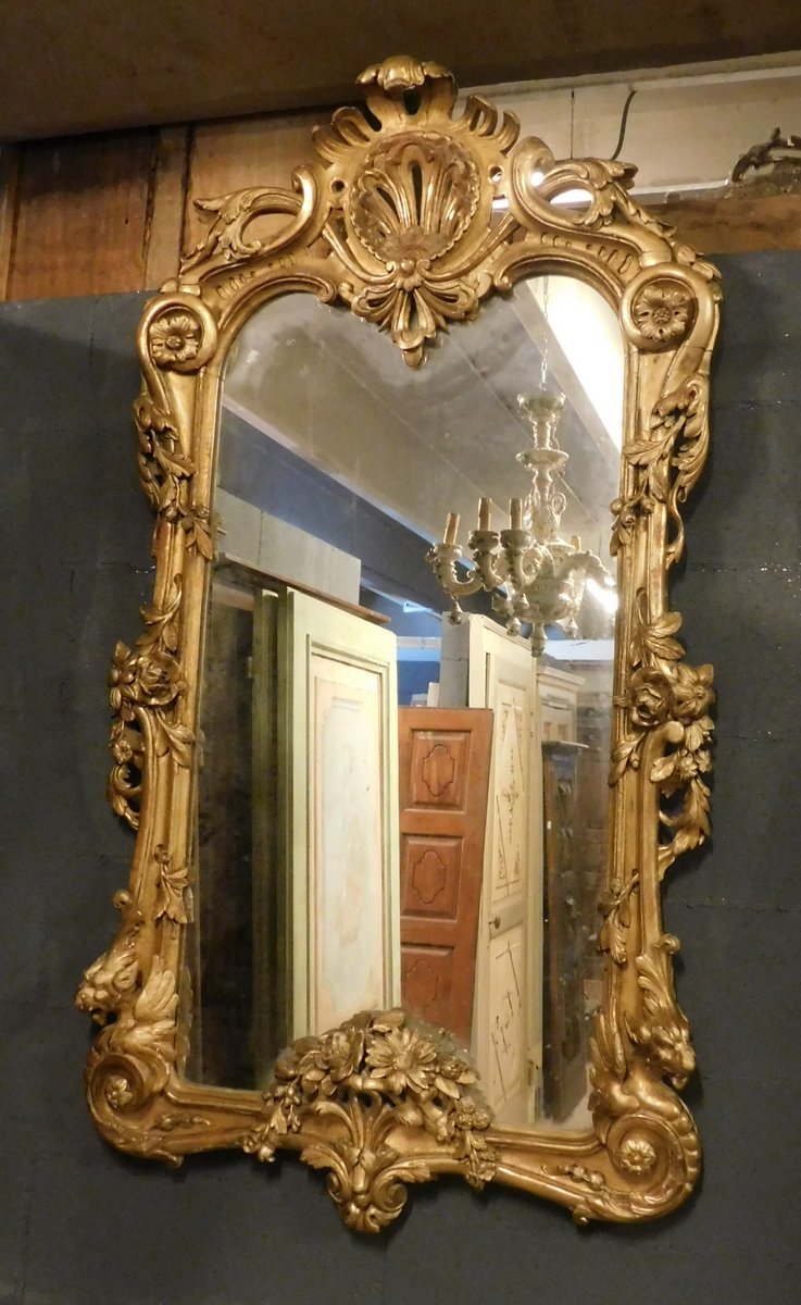 A specc218 carved and gilded mirror,meas. h cm 146 x 80