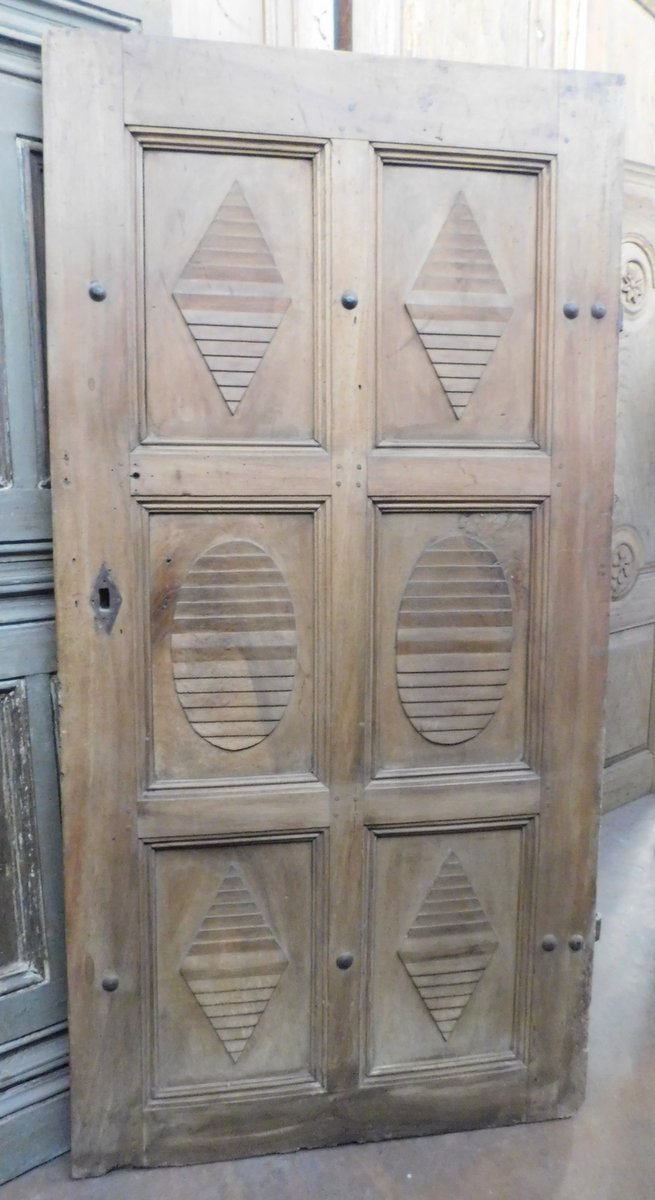A ptcr436- walnut door with carved shapes, eighteenth century, cm l 102 x h 201 